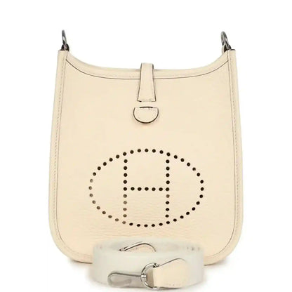 Small hobo crossbody bag in pale cream textured leather, perforated logo front
