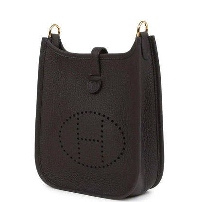 Black leather Evelyne TPM bag angled view with perforated logo and gold-tone top rings.