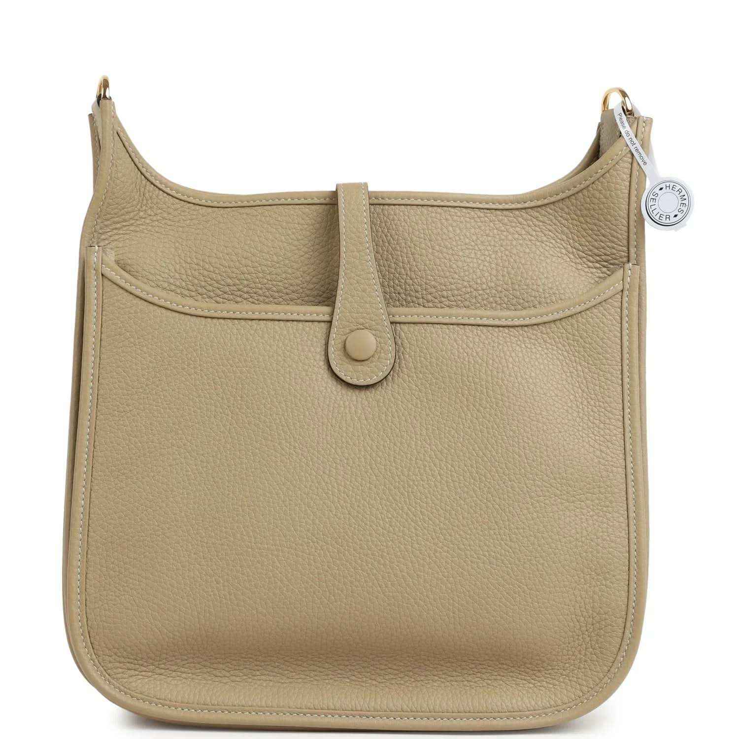Small tan textured leather shoulder bag with gold-toned hardware and front tab closure
