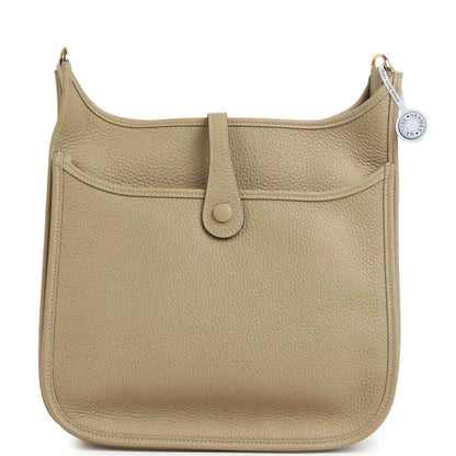 Small tan textured leather shoulder bag with gold-toned hardware and front tab closure