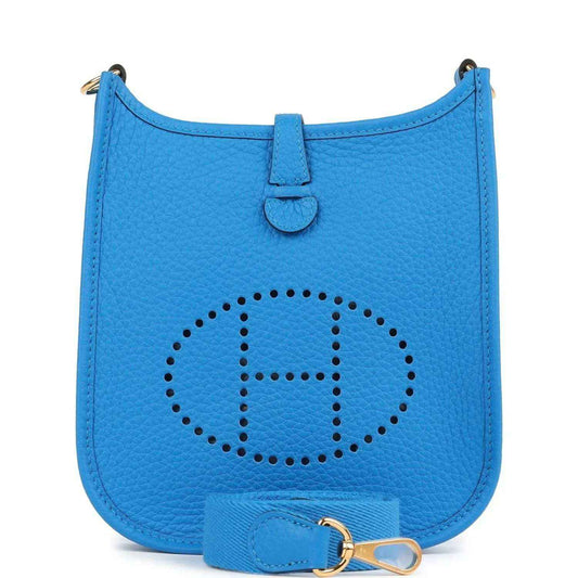 Blue leather Evelyne TPM style crossbody bag with stitched logo emblem on front flap.