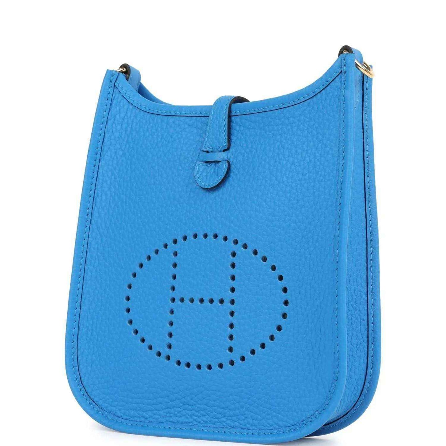 Blue leather Evelyne TPM style crossbody bag with front dotted emblem and stitched trim.
