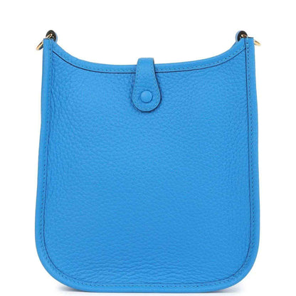 Blue leather Evelyne TPM style crossbody bag with smooth front panel and top flap closure.