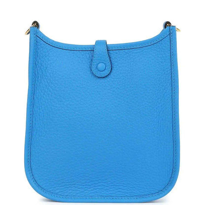 Blue leather Evelyne TPM style crossbody bag with smooth front panel and top flap closure.