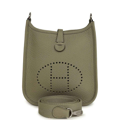 Sage green leather crossbody bag with perforated Evelyne logo and adjustable strap