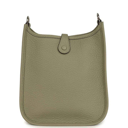 Sage green leather crossbody bag with top tab closure and silver-tone rings