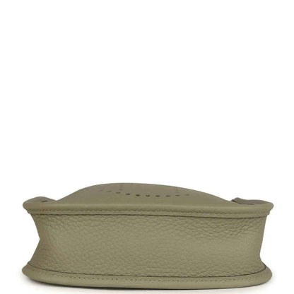 Sage green leather crossbody bag base with stitched edge and curved shape