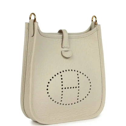 Hermes Evelyne TPM mini bag, light beige, front with dotted H logo and gold handles