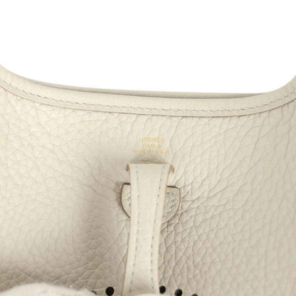 Hermes Evelyne TPM mini bag close-up of light beige textured leather and center tab