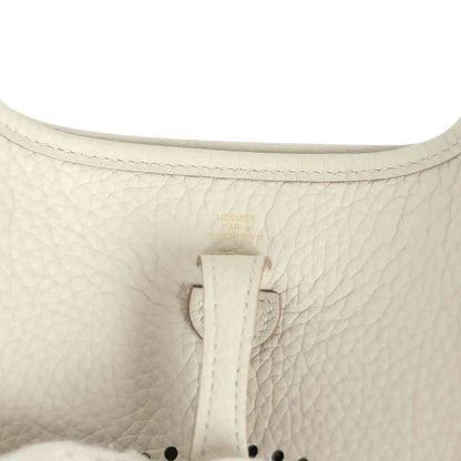 Hermes Evelyne TPM mini bag close-up of light beige textured leather and center tab
