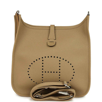 Tan leather hobo crossbody bag with perforated logo and front zipper pull