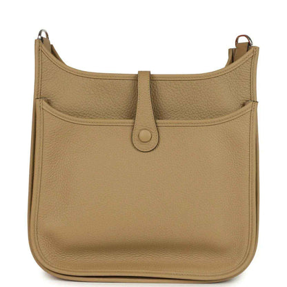 Tan leather hobo crossbody bag with front flap seam and center strap tab