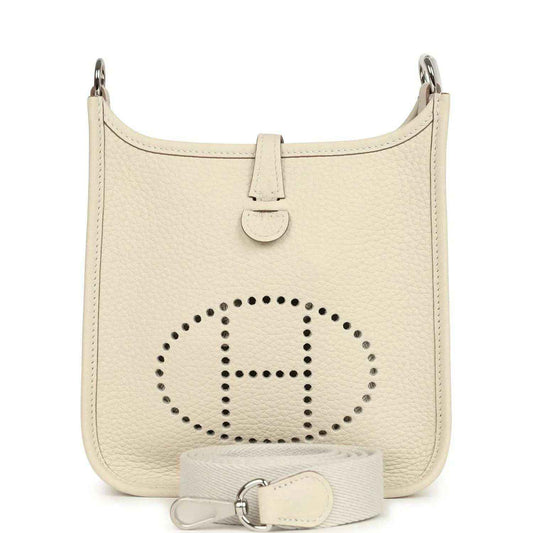 Mini leather hobo bag in light cream with perforated logo and top handle straps