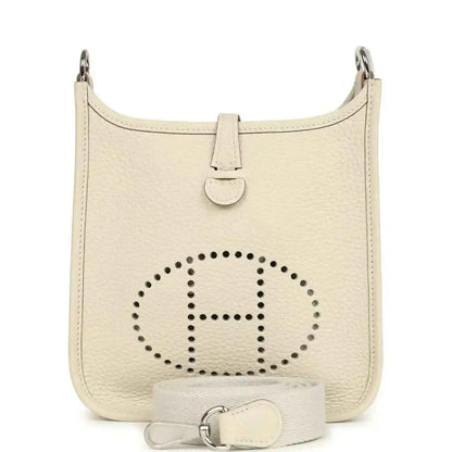 Mini leather hobo bag in light cream with perforated logo and top handle straps