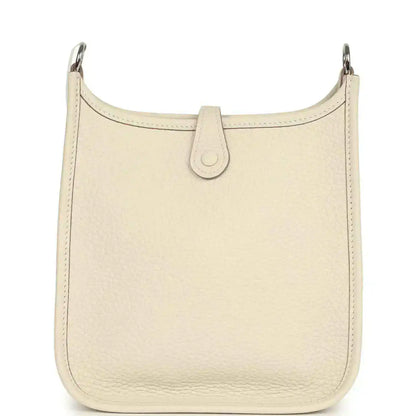 Cream leather hobo bag front with central pull-tab detail and smooth top edge
