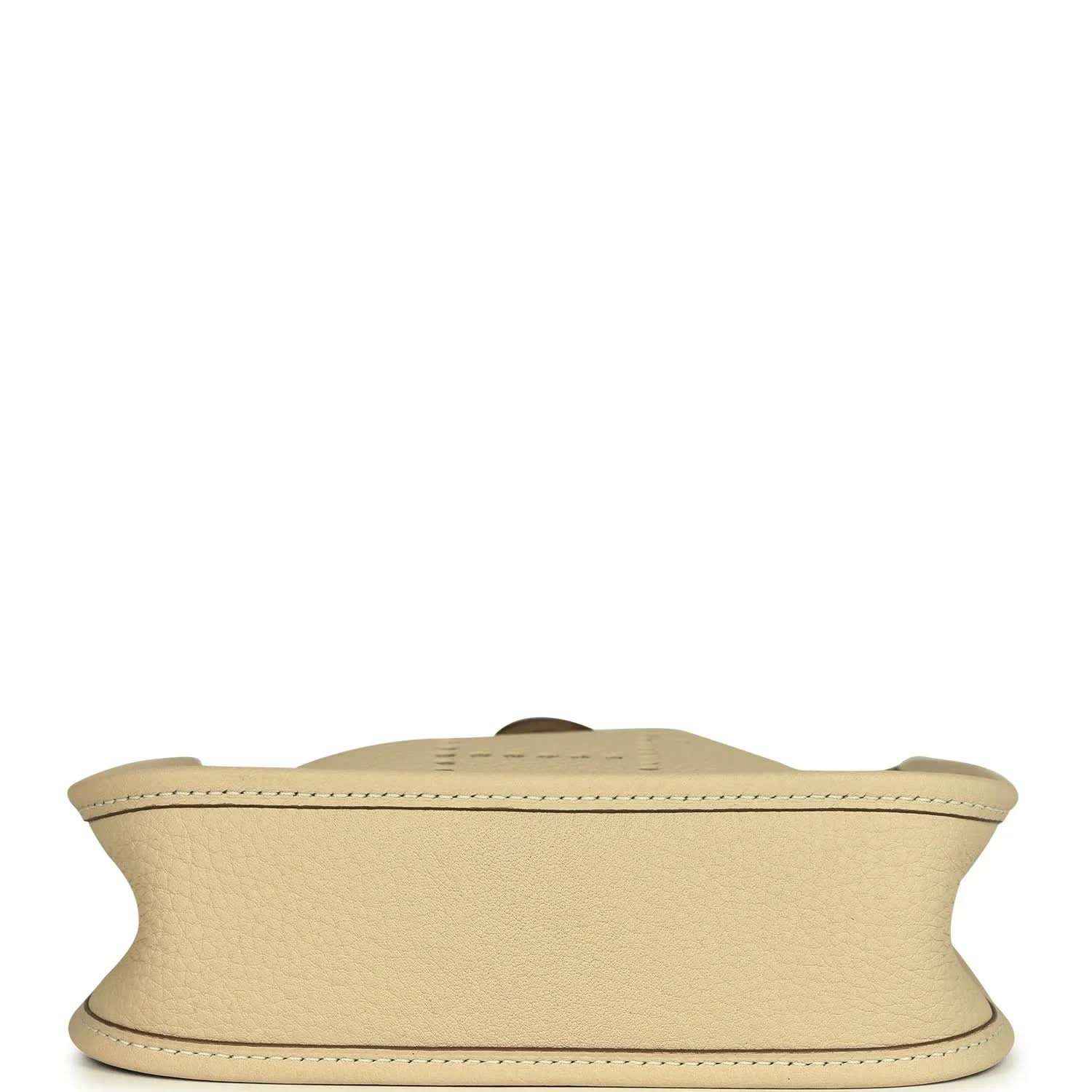 Light cream leather bag bottom view with visible seam along the base edge