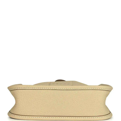 Light cream leather bag bottom view with visible seam along the base edge