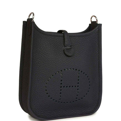 Evelyne TPM bag in dark leather with perforated logo panel and top handle rings