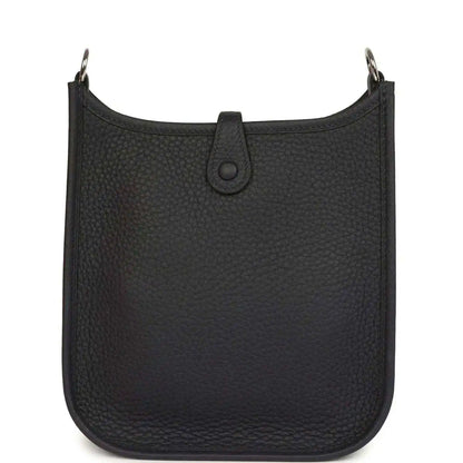Evelyne TPM bag in dark leather with top opening and central strap tab detail