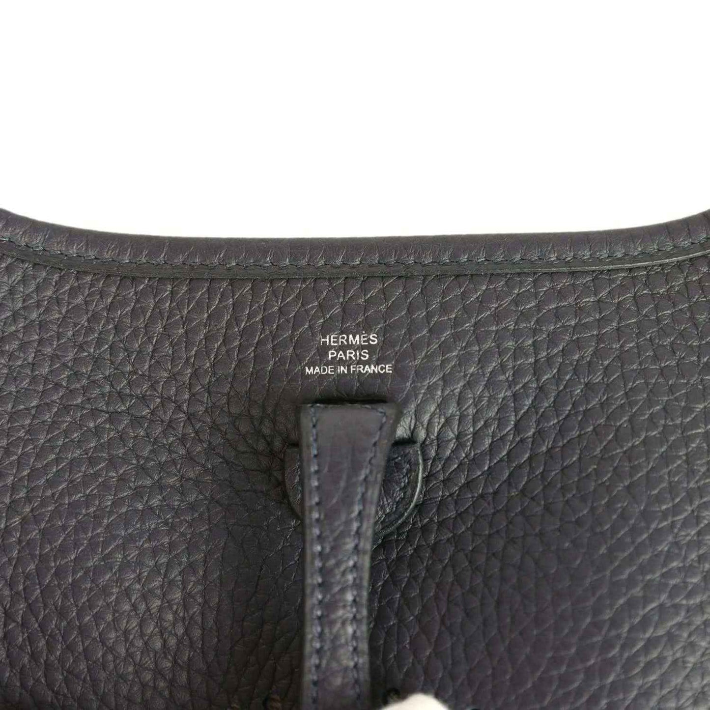 Evelyne TPM bag close-up of leather label reading “HERMÈS PARIS MADE IN FRANCE”