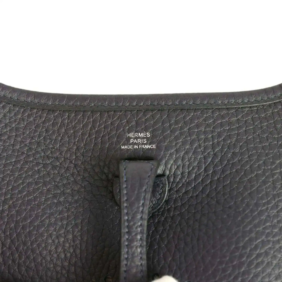 Evelyne TPM bag close-up of leather label reading “HERMÈS PARIS MADE IN FRANCE”