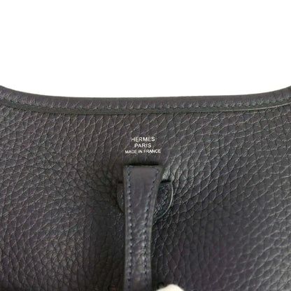 Evelyne TPM bag close-up of leather label reading “HERMÈS PARIS MADE IN FRANCE”
