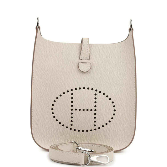Mini shoulder bag in light beige textured leather with logo medallion and top clasp