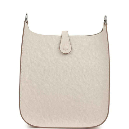 Light beige textured leather hobo-style bag with front snap tab and silver-tone rings