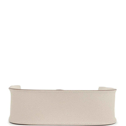 Light beige textured leather handbag profile with wide base and open top edge