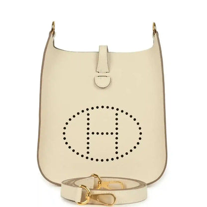 Cream leather crossbody bag with dotted 'H' logo, gold-tone hardware and short strap