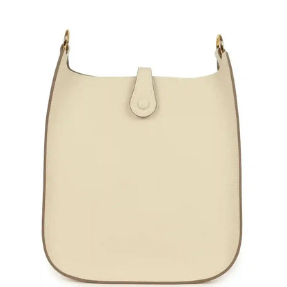 Cream leather crossbody bag front with top strap and central leather tab