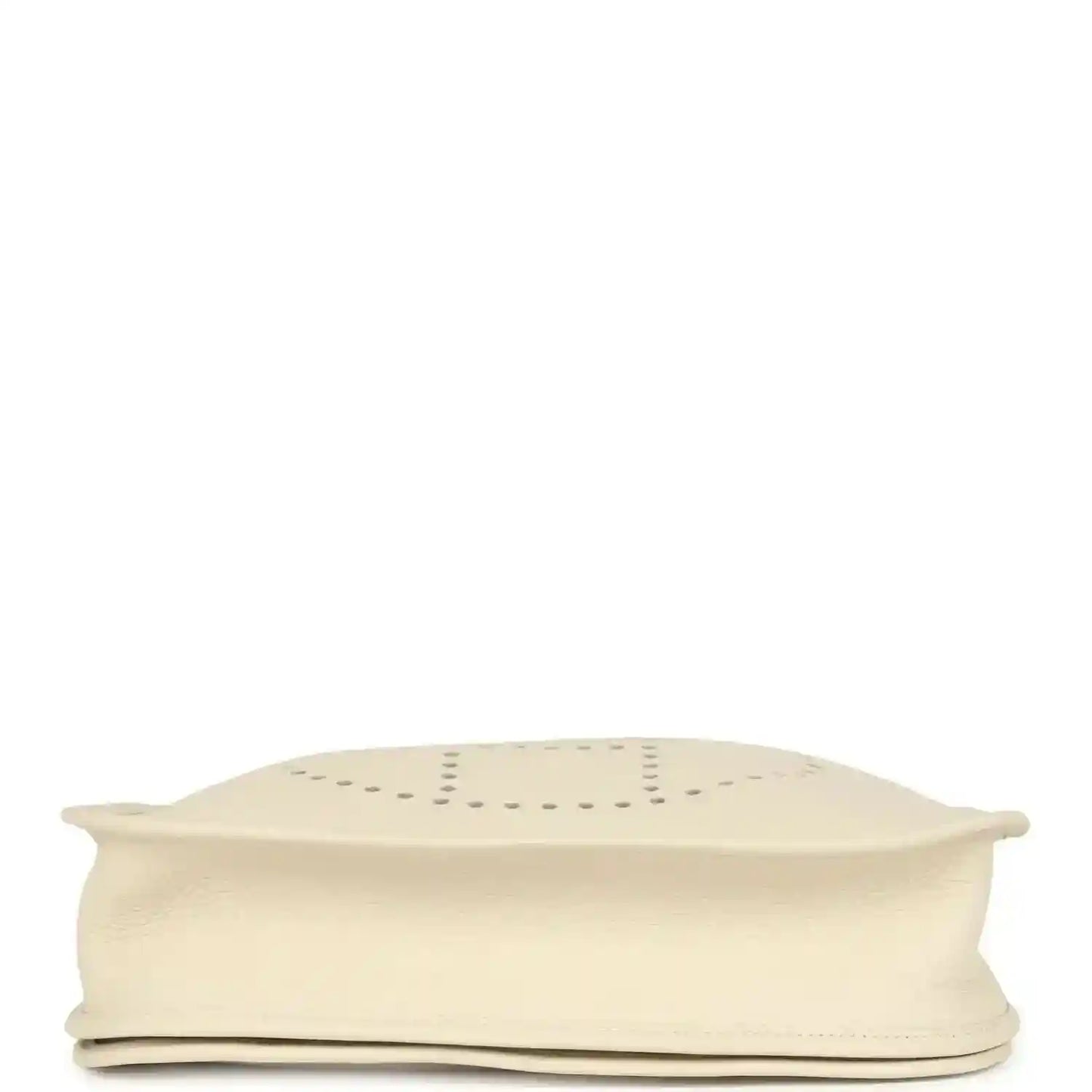 Folded-over cream bag flap edge shown from underside, with visible seam and stitching details.