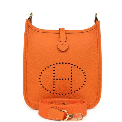 Orange Clemence leather crossbody bag with dotted Hermes logo and front strap tab