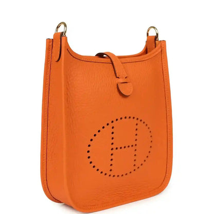 Orange Clemence leather crossbody bag with dotted Hermes logo and top handle loop