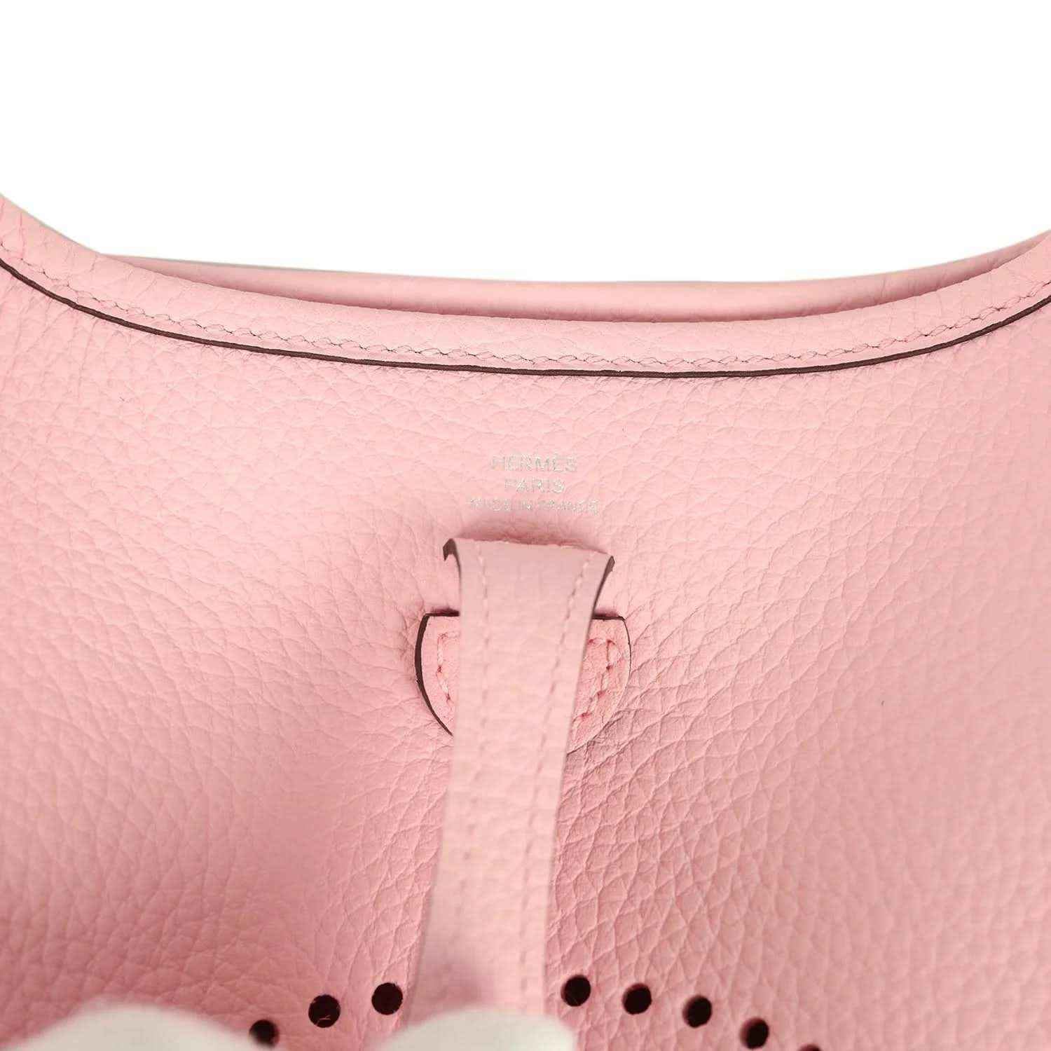 Rose pink leather Evelyne TPM bag close-up of top tab and dotted logo