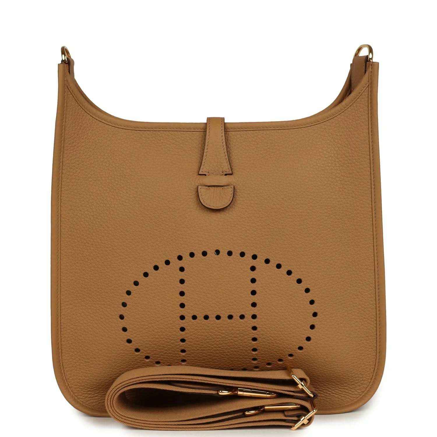 Tan leather hobo bag with perforated logo, snap tab, and gold hardware