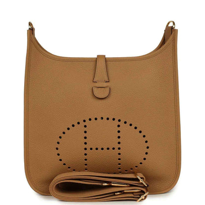 Tan leather hobo bag with perforated logo, snap tab, and gold hardware