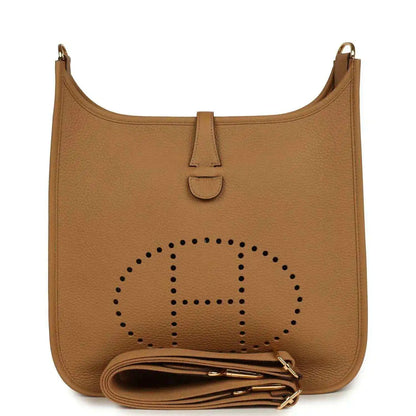 Tan leather hobo bag with perforated logo, snap tab, and gold hardware