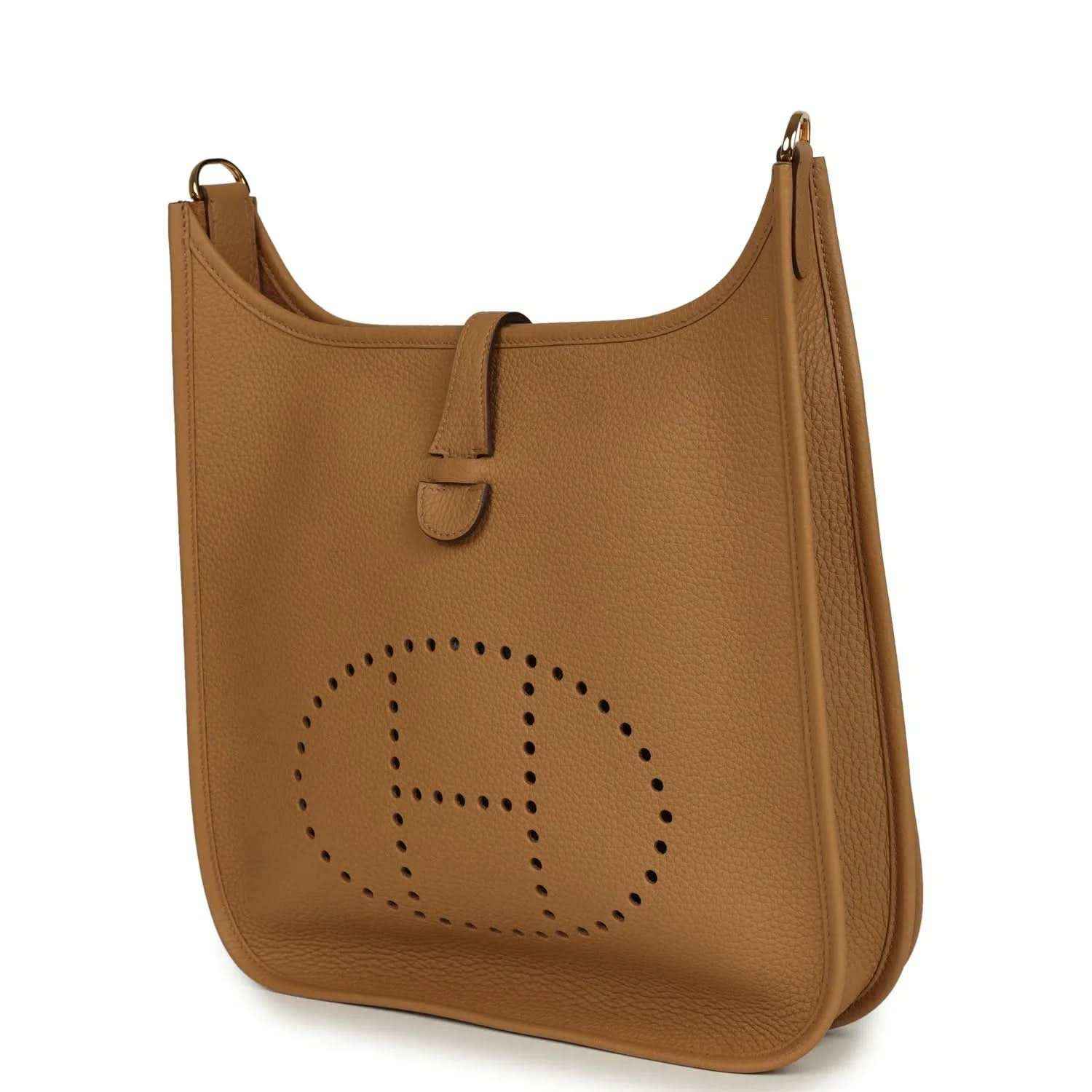Tan leather hobo bag with perforated logo medallion and top handle strap