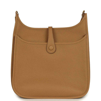 Tan leather hobo bag with front pocket, snap closure, and gold-tone hardware