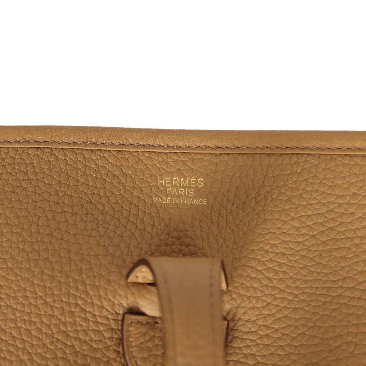 Tan leather bag close-up with Hermes Paris Made in France stamp and strap hardware