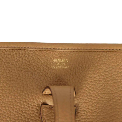 Tan leather bag close-up with Hermes Paris Made in France stamp and strap hardware
