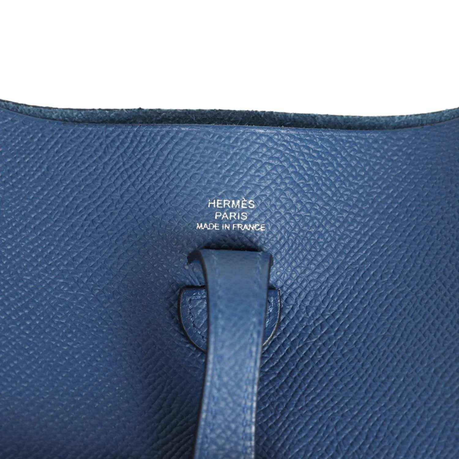 Blue leather bag interior label with Hermes text on textured Epsom surface