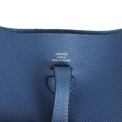 Blue leather bag interior label with Hermes text on textured Epsom surface