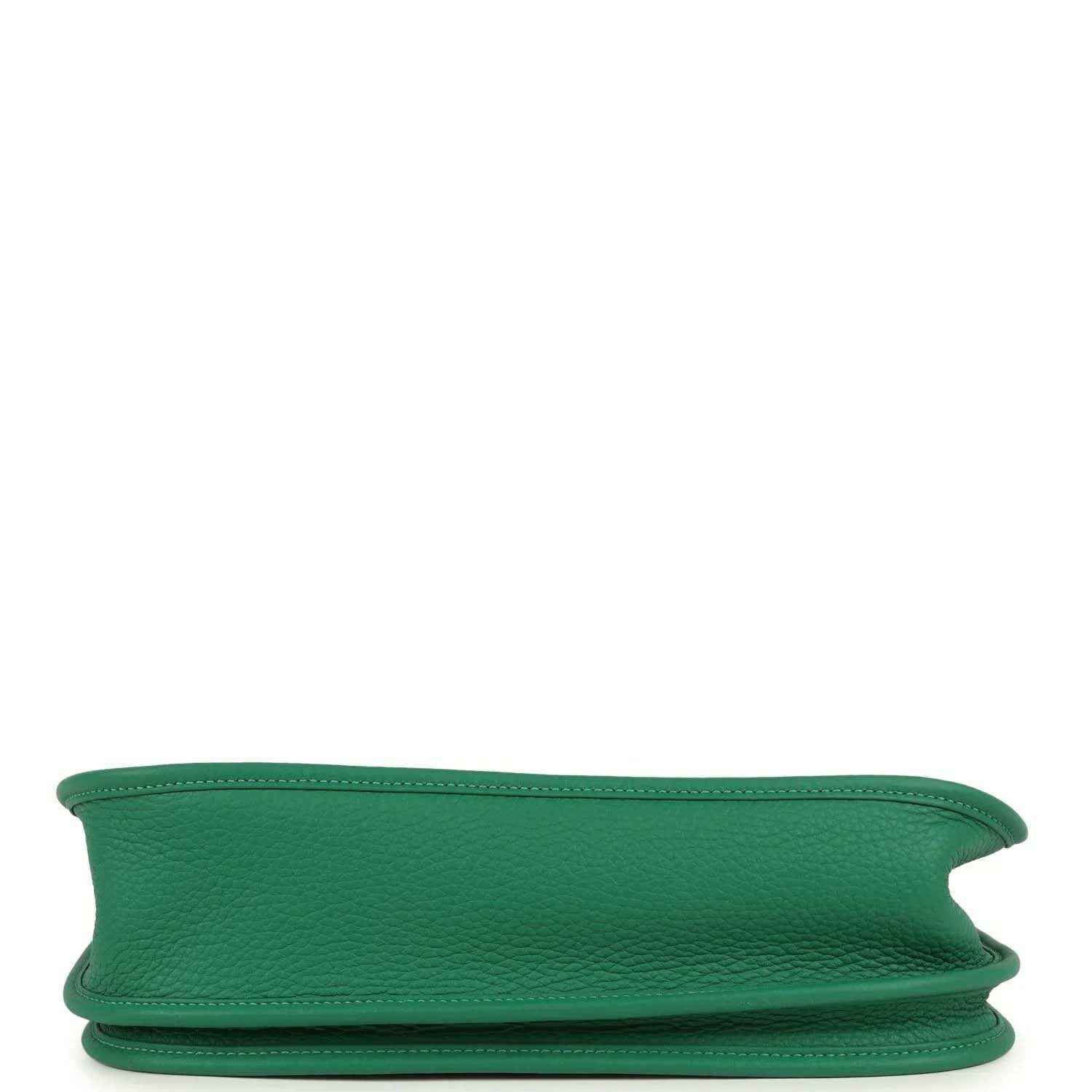 Green leather crossbody bag bottom edge view with visible side seams