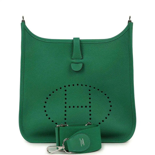 Green leather crossbody bag with perforated logo and small pouch with keyring