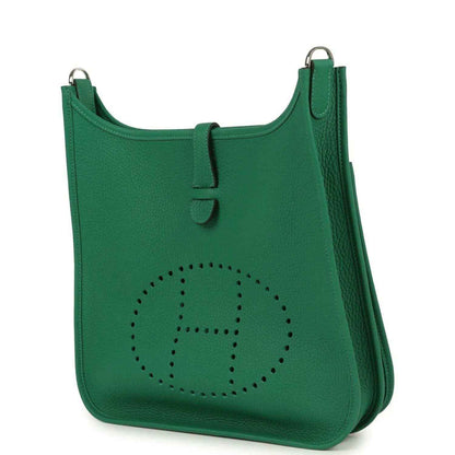 Green leather crossbody bag with perforated logo and side pocket detail