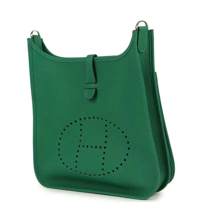 Green leather crossbody bag with perforated logo and side pocket detail