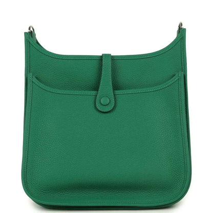 Green leather crossbody bag with front flap pocket and top snap button