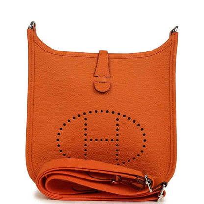 Orange leather hobo bag with perforated 'E' emblem, top handle, and visible strap